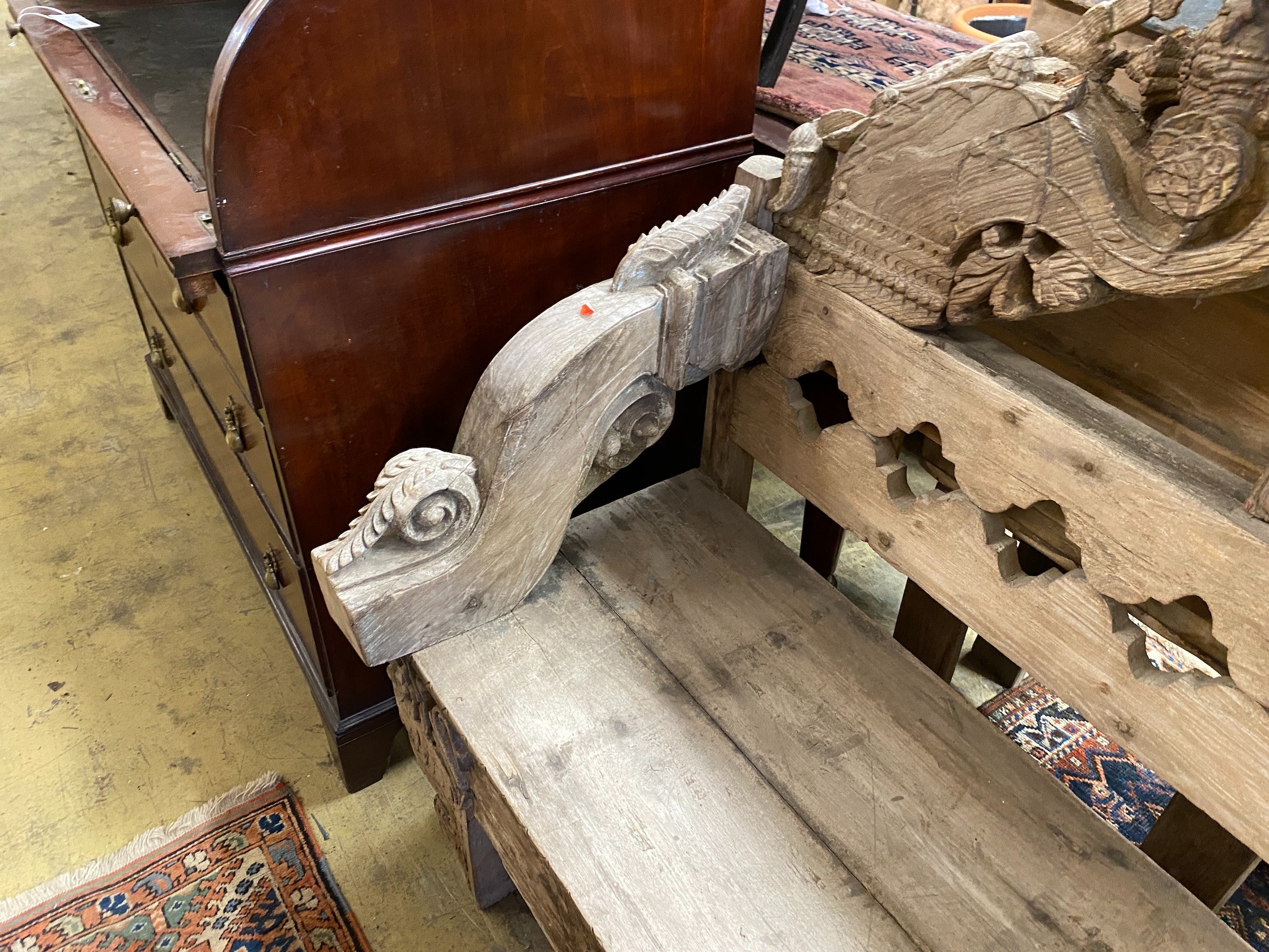 An Indonesian bleached carved hardwood bench seat, length 124cm, depth 50cm, height 111cm